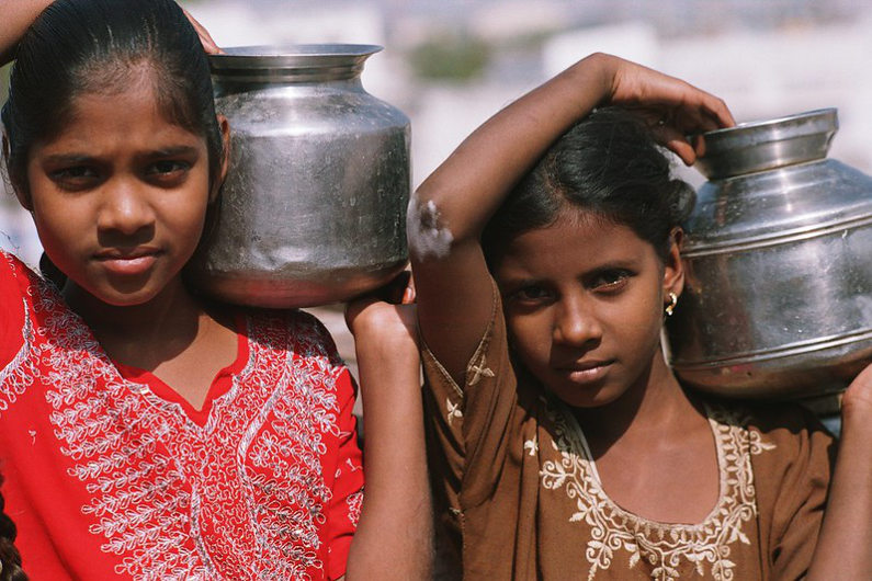 Girls carrying water in India